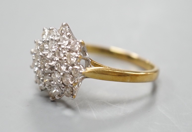 A modern 18ct gold and diamond cluster set flower head ring, size R/S, gross weight 5.5. grams.